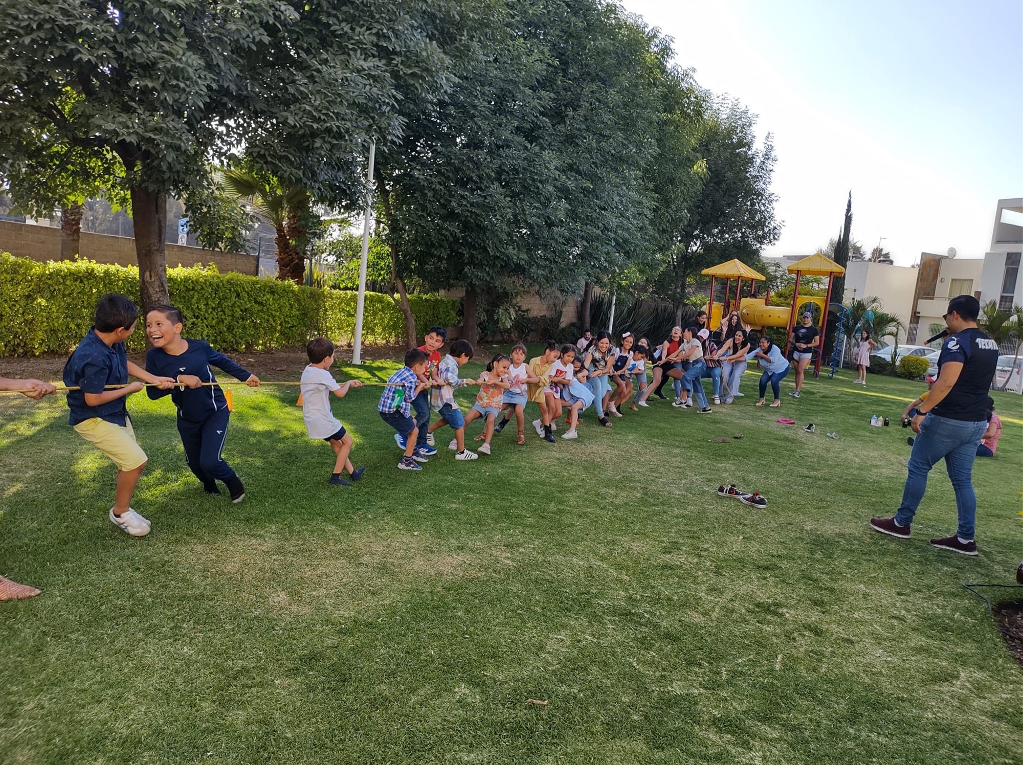 School and group kids pulling together in a tug-of-war at a Grazie Mille field day