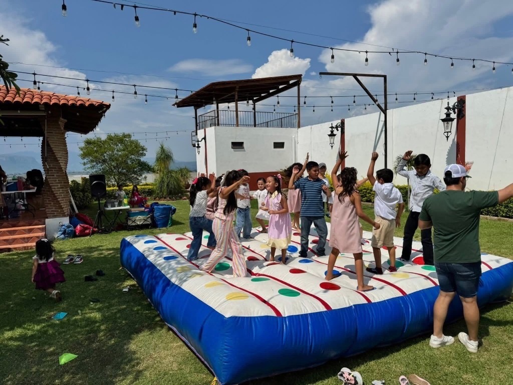 Kids playing on a giant outdoor game mat