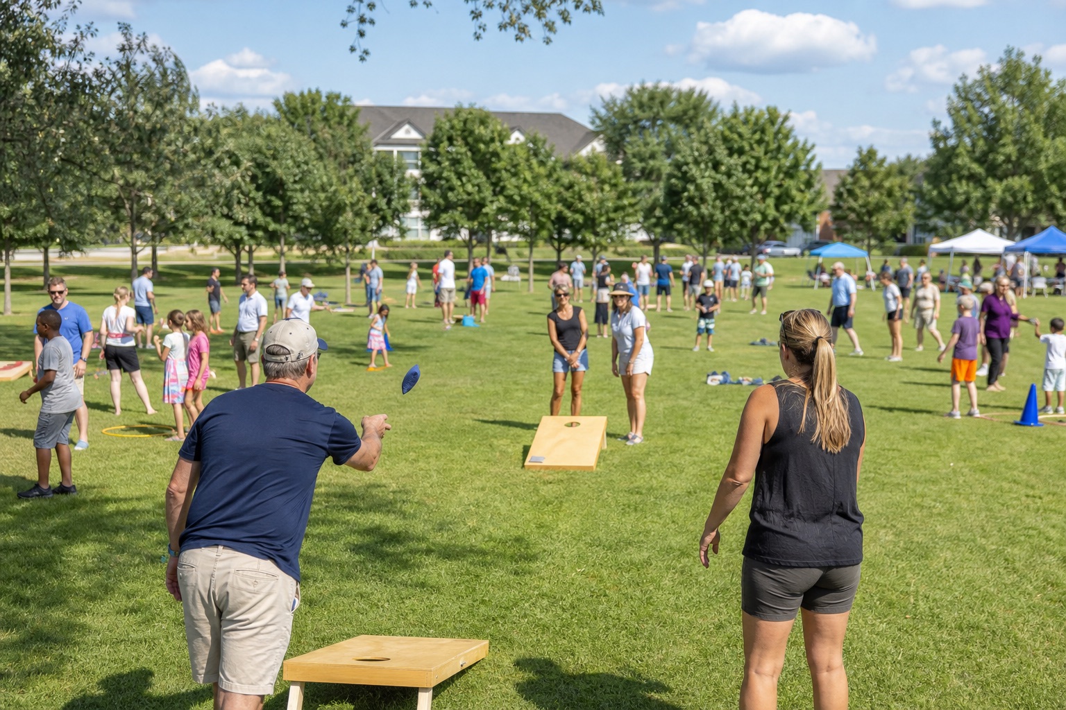 Neighbors and families playing lawn games together in an open community park